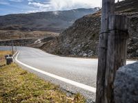 the view of an empty road in the mountains from inside the vehicle's cabin