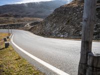 the view of an empty road in the mountains from inside the vehicle's cabin