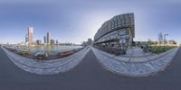 a 360 - angle image of the downtown cityscape from the sidewalk and on a boat