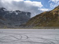 a person riding a motorcycle down the road next to a mountain and valley in front of them