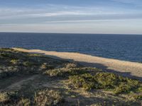 the ocean is empty of people on the beach by the sand path near the shore