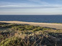 the ocean is empty of people on the beach by the sand path near the shore