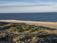 the ocean is empty of people on the beach by the sand path near the shore