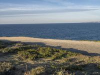 the ocean is empty of people on the beach by the sand path near the shore