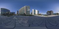 a panoramic view of buildings and gardens that look like they are taken with a fish eye lens