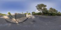 a street view shows what looks like a lot with dirt, shrubs and a fence