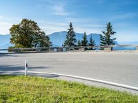 a person riding on the back of a skateboard down a hill side road in the countryside