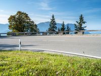 a person riding on the back of a skateboard down a hill side road in the countryside