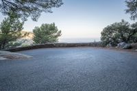 a curve and an ocean as seen from a road on the cliffs side of a mountain