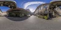 360 - sphere panoramic view of a street in europe with cars passing by