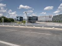 a street with a bike on a bridge next to a building and road with some wires