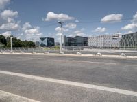 a street with a bike on a bridge next to a building and road with some wires