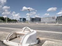 a street with a bike on a bridge next to a building and road with some wires