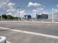 a street with a bike on a bridge next to a building and road with some wires