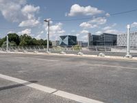 a street with a bike on a bridge next to a building and road with some wires