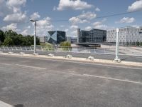 a street with a bike on a bridge next to a building and road with some wires