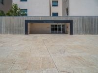 the gray concrete walls of a building have a line of steps on the left side