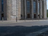 an entrance of a building with large columns and doors that spell out the word voltege