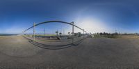 the camera panoramic image shows an artistic view of a bridge with a sculpture in front