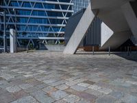 the building has several different angles on it, in varying colors and shapes with brick and concrete floors