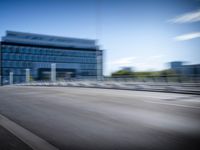 a blurry picture shows a truck driving on the road and a building in the background