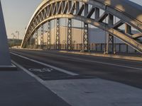 a bicycle lane and bike lane on a bridge in the background, with an overpass,