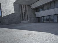 an open air jetliner parked in front of the entrance of a building on concrete