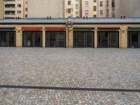 a public building with an umbrella that has been decorated on top by colorful striped curtains