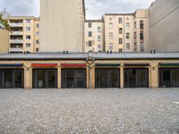 a public building with an umbrella that has been decorated on top by colorful striped curtains