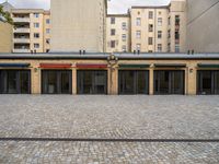 a public building with an umbrella that has been decorated on top by colorful striped curtains