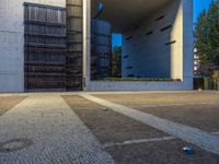 a parking lot surrounded by concrete walls and large windows with vertical lines down the middle of it