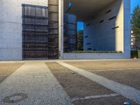 a parking lot surrounded by concrete walls and large windows with vertical lines down the middle of it