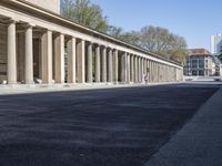 a city street is empty and has columns on the sides of it with pillars in the center