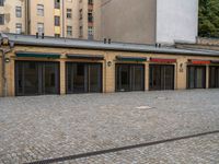 an empty parking lot is shown in this image is clear outside of the buildings with doors