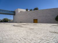 a big concrete building with an entrance and a yellow door in the center of it