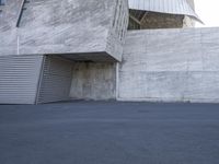 an open air parking garage with an outside area that has two sliding doors on it