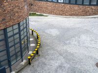 an overhead shot shows a street and building with a bus on it's side