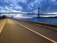 the long path leads to the large bridge, with a bright light shining from under it