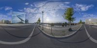 this is a 360 - view of a street in a modern city, with buildings and water