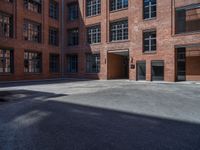 an empty building with three large windows and a parking lot in front of it,