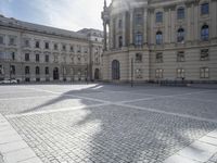 the empty sidewalk is shown in front of the building, and it seems to be lined with white stone