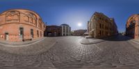 360 - zoom image of the street with buildings and a clock at the corner in the sun