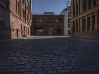 street view of buildings from outside at dusk in old european city with cobblestone pavement