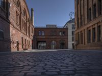 street view of buildings from outside at dusk in old european city with cobblestone pavement