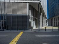 the empty street with bicycles parked in front of the buildings has a sign that says the library on it