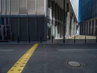 the empty street with bicycles parked in front of the buildings has a sign that says the library on it