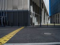 the empty street with bicycles parked in front of the buildings has a sign that says the library on it