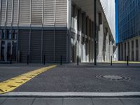 the empty street with bicycles parked in front of the buildings has a sign that says the library on it