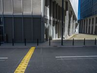 the empty street with bicycles parked in front of the buildings has a sign that says the library on it