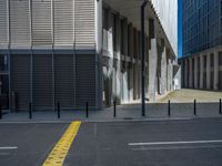 the empty street with bicycles parked in front of the buildings has a sign that says the library on it